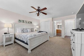 A bedroom with a bed, nightstands, a ceiling fan, and a dresser. - StoneBridge Condo Near SDC w Onsite Golf Course_Screen Porch_Free Attraction Tickets (Branson West)