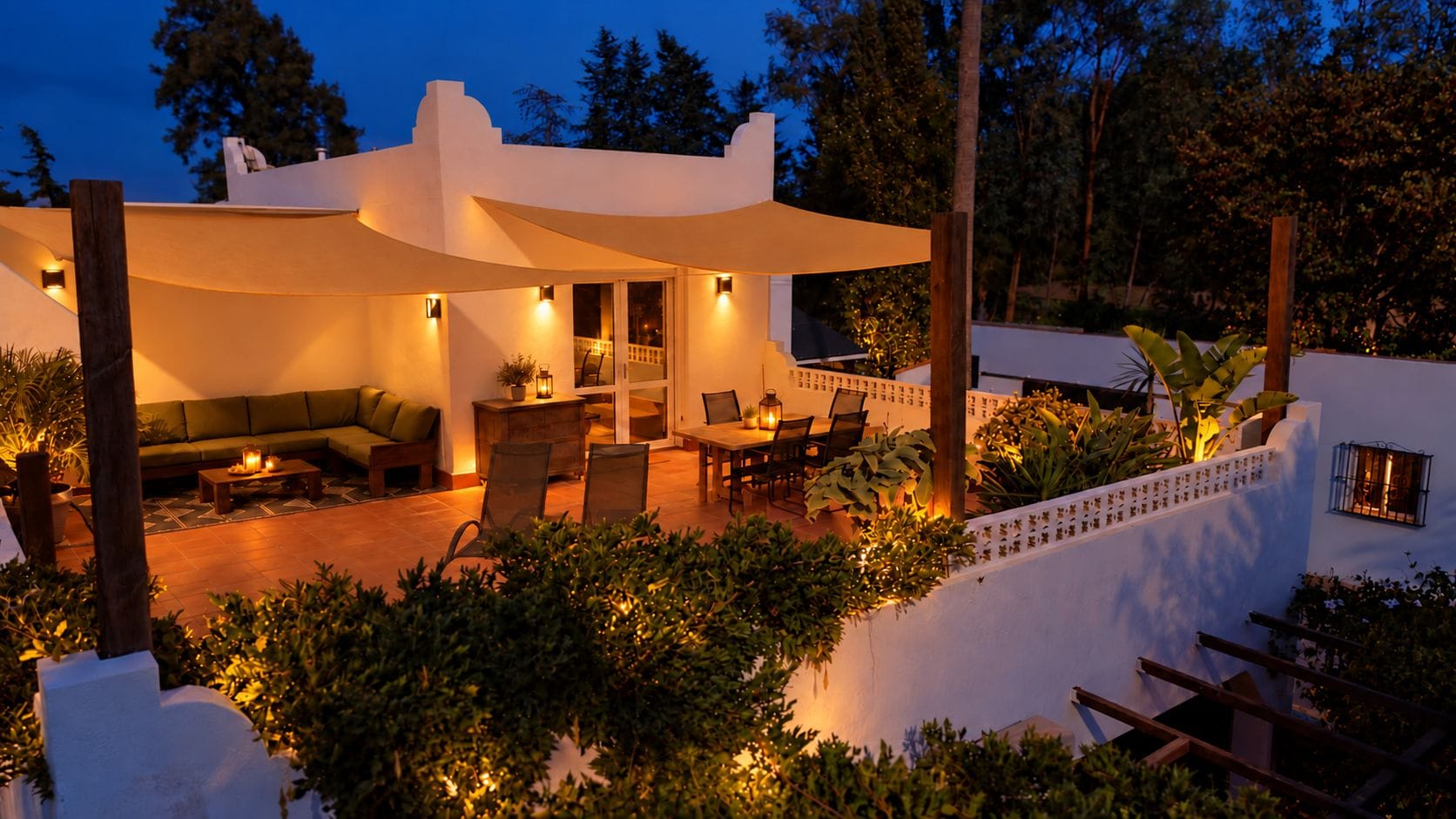 A modern outdoor patio area with a dining set, seating, and ambient lighting.