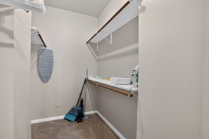 A small bathroom with a shower, a sink, and a mirror. There is a towel rack and a broom. - Comfortable Living in Saddlebrook (Lumberton)