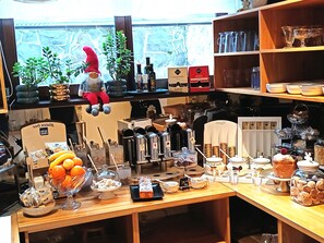 A breakfast bar with various food items and a decorative gnome. - Perfect 1-bedroom hotel with AC in welcoming Plitvica Selo (Plitvica Selo)