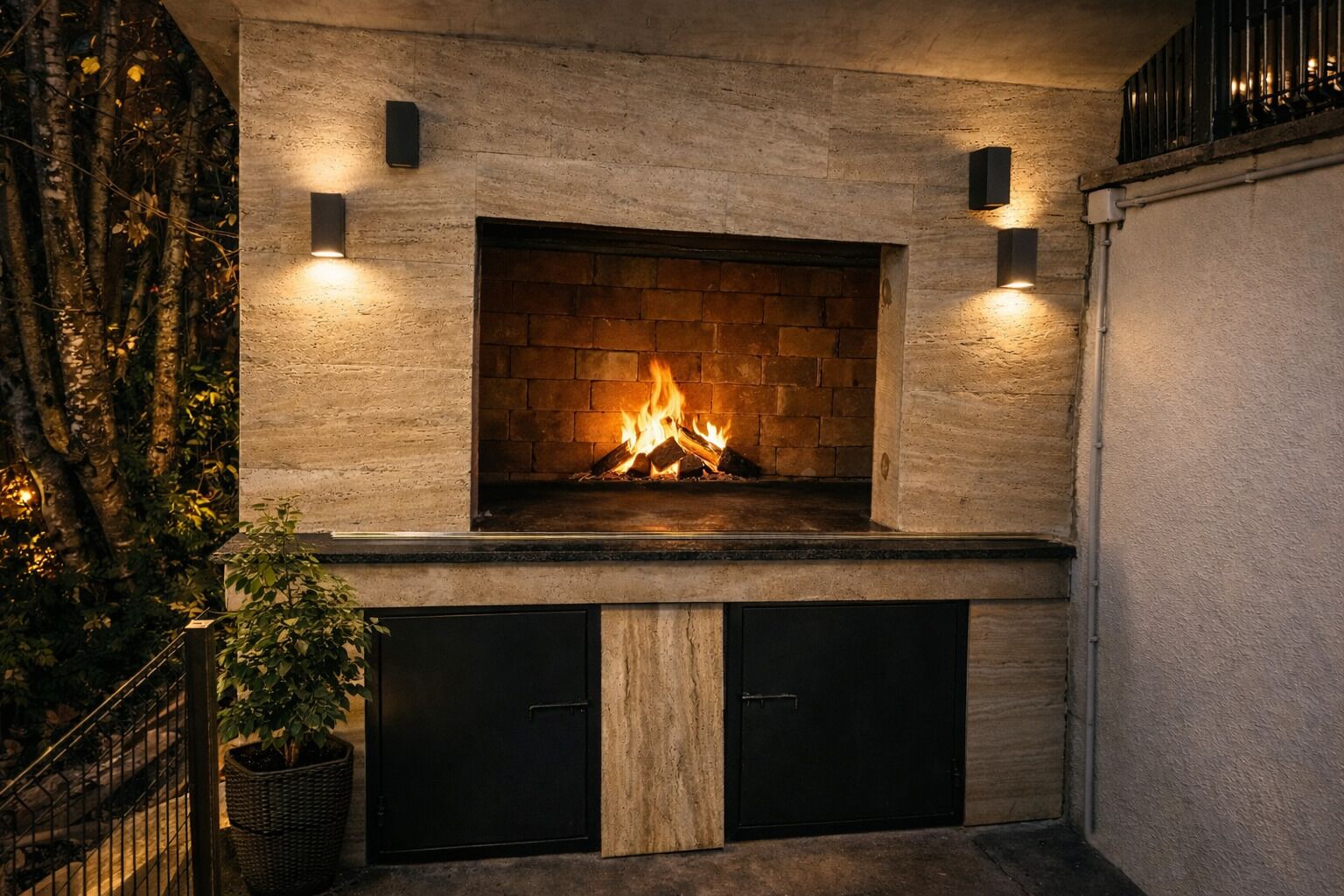 A fireplace with a fire, flanked by two black cabinets and two wall-mounted lights.