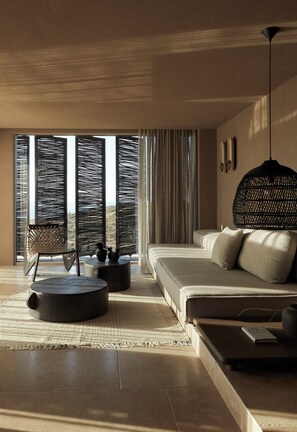 A modern bedroom with a large bed, a hanging light fixture, and a view through the window. - The Tierras - Phōs | 2 Bedroom Maisonette Private Pool Villa (Mononaftis)