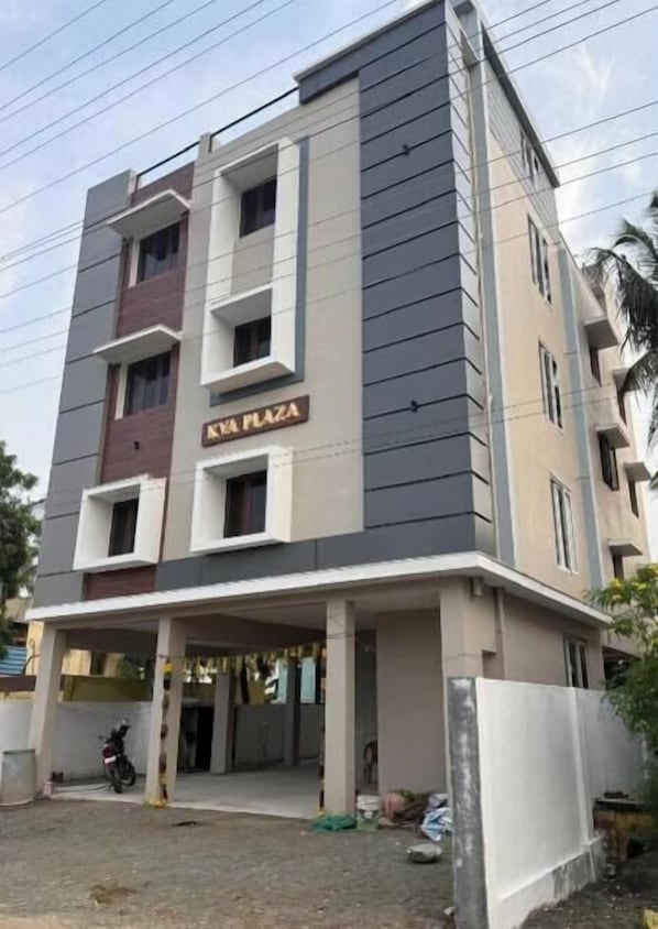 A multi-story building with a sign reading 'KIA PLAZA'. - KVA Plaza Service Apartments (Palayankottai)