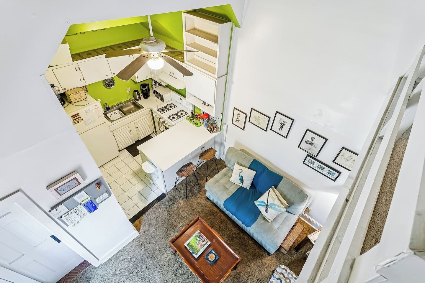 A modern apartment with a kitchen, dining area, and living room.