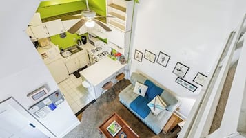 A modern apartment with a kitchen, dining area, and living room.