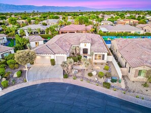 A residential area with houses, a swimming pool, and a curved driveway. - All Inclusive- Nine Cities One Oasis/Game Room (Indio)