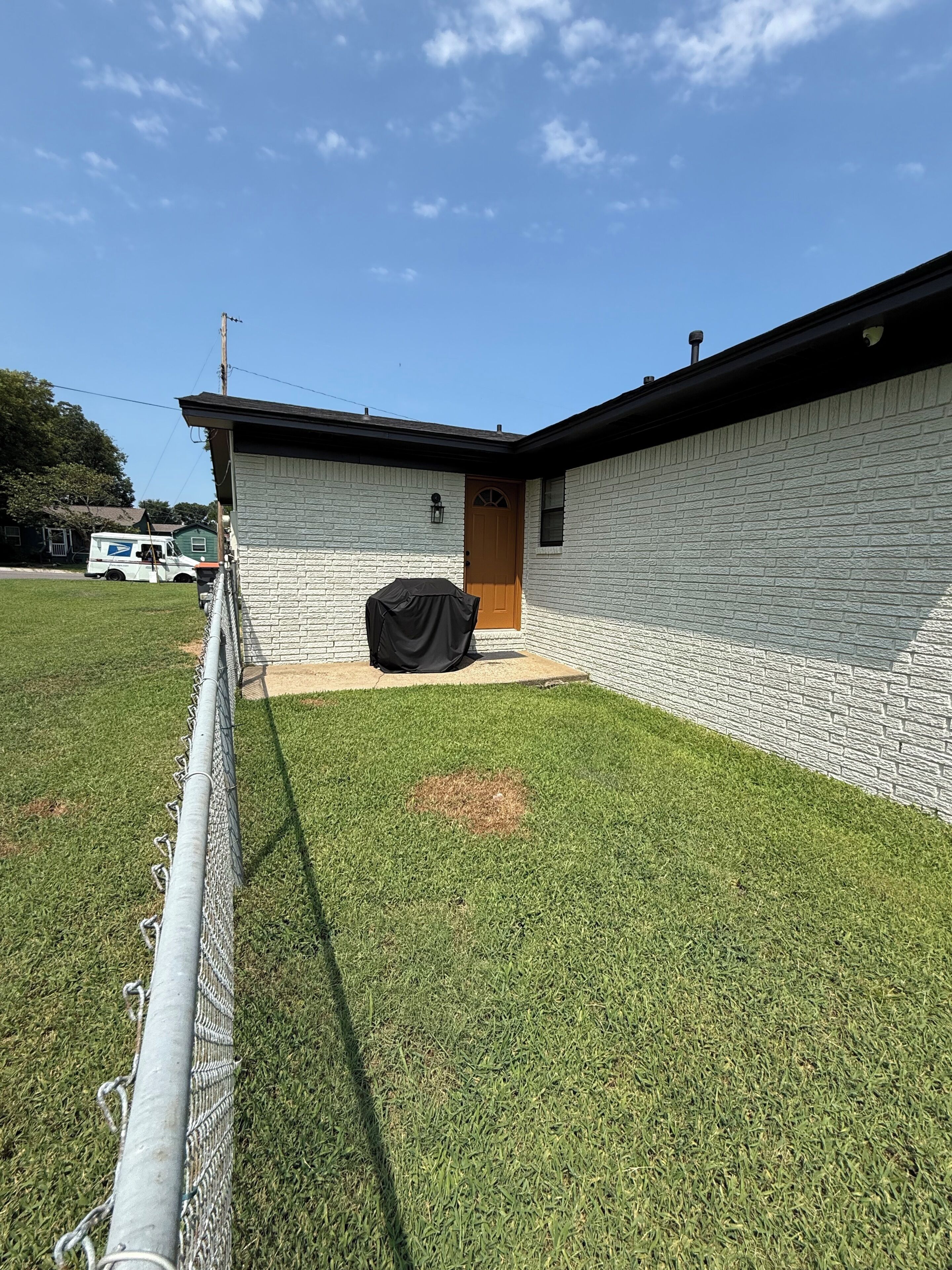 A building with a brick exterior and a wooden door.