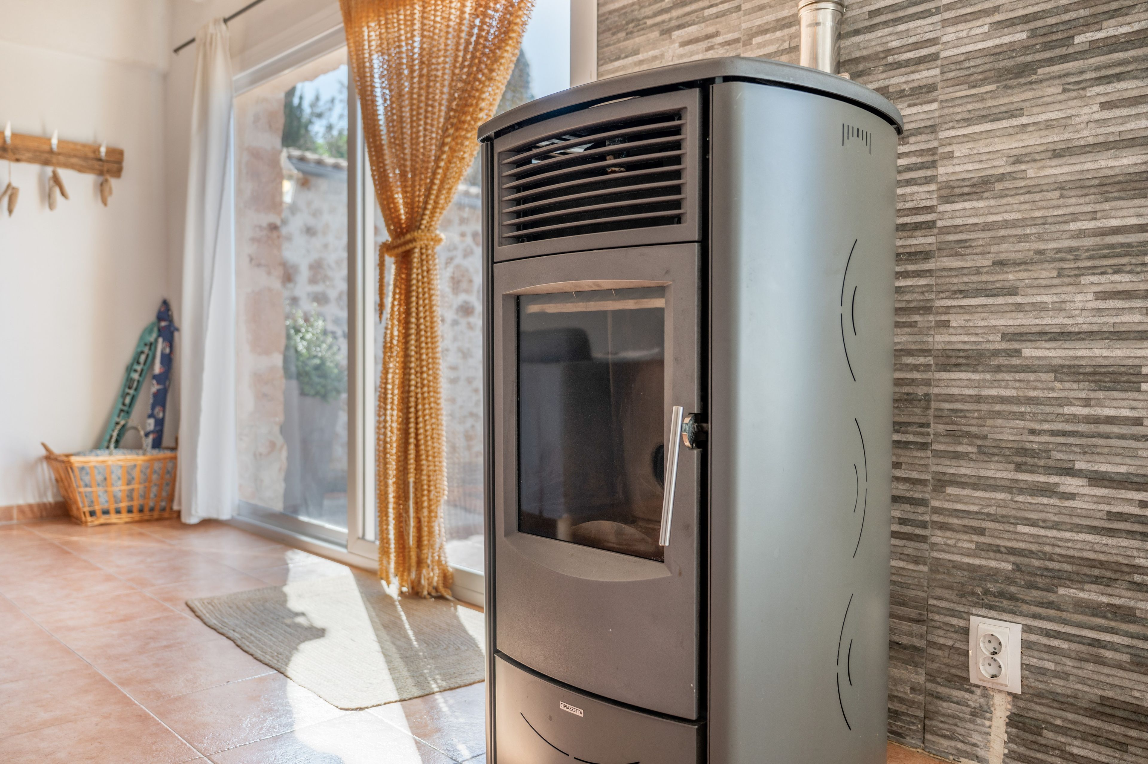 Una cucina moderna con piano cottura integrato, una finestra vista e un cesto di vimini sul pavimento.
