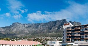 A residential area with a prominent mountain in the background. - Stylish Gardens Apt Views, Steps from Kloof Street (Cape Town)