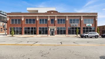 A red brick building with large windows and a flat roof.