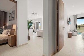 A modern living room with a sofa, a dining area, and a view of a pool. - Private Pool | 2BR Retreat | Near Eagle Beach (Noord)
