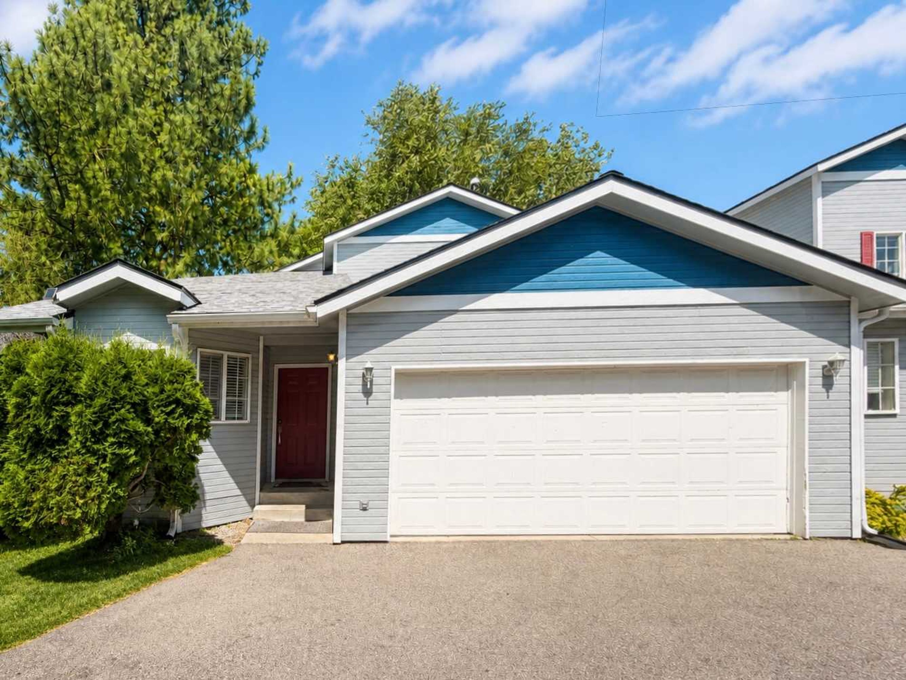 A residential house with a garage, a front door, and a driveway.