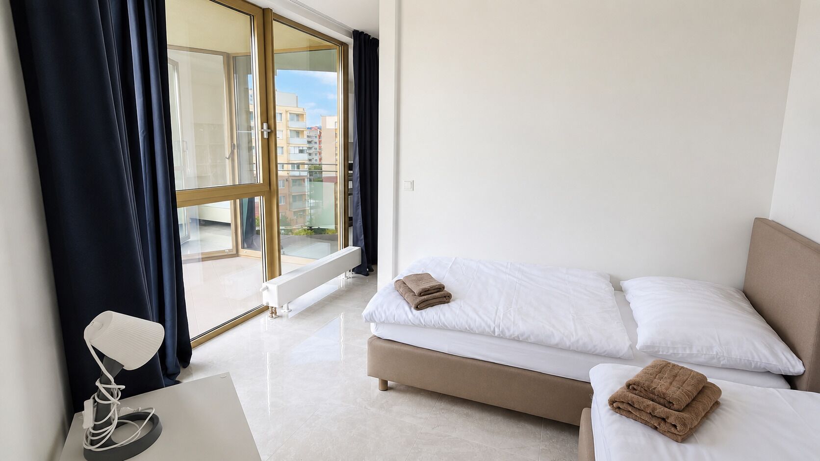Ein Hotelzimmer mit Bett, Schreibtisch und Blick ins Freie.