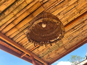 A ceiling with a woven, circular structure hanging from it. - Oloresho Safari Lodge (Arusha)