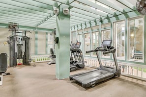 A gym with treadmills, a weight machine, and a fan. - Relax, Recharge, Repeat: Hilton Head Resort Condo (Hilton Head Island)