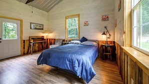A bedroom with a bed, a desk, a chair, a window, and a painting on the wall. - Outdoor Oasis w/ Mtn Views! 5-acre Augusta Getaway (Augusta)