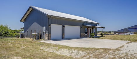 A single-story industrial building with a metal roof and two large garage doors.
