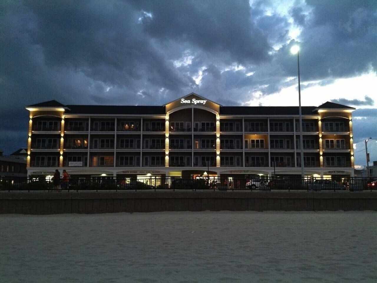 A multi-story hotel with a prominent sign reading 'Sea Spray.'