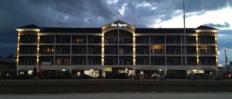 A multi-story hotel with a prominent sign reading 'Sea Spray.'
