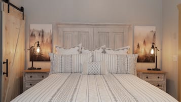 Un dormitorio con una cama grande, dos mesitas de noche, un armario de madera y dos lámparas de pared.