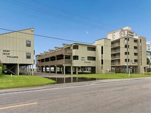 A multi-story building with balconies and a flat roof, labeled '1027 Gulf Village.' - Gulf Village #203 | Gulf Shores Condo with + Community Pool (Gulf Shores)
