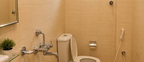 A bathroom with a sink, toilet, and shower.
