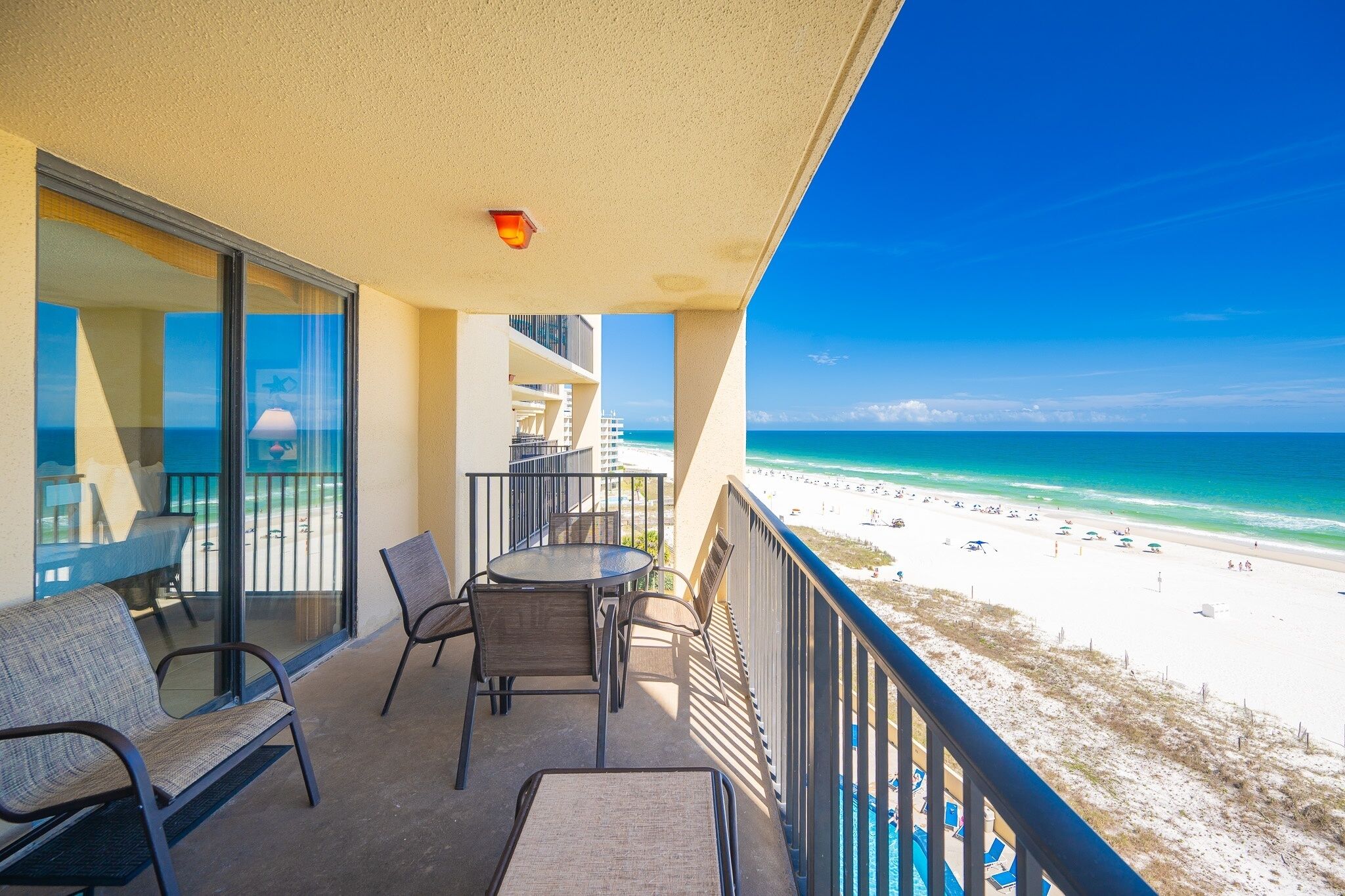 A balcony with a view of a beach and ocean.