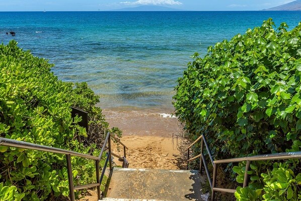 A staircase leading to a beach with clear blue water and a mountain in the background. - Wailea Ekahi 3a 2 Bedroom Condo (Kihei)