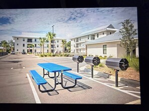 A parking area with a picnic table and mailboxes. - Salt & Serenity on 30A Walk to Santa Rosa Beach! 
CLEAN, 1st Floor Unit (Santa Rosa Beach,)