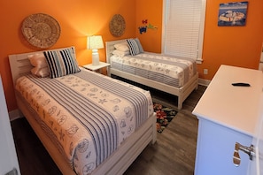 A bedroom with two beds, a desk, and a window with blinds. - Salt & Serenity on 30A Walk to Santa Rosa Beach! 
CLEAN, 1st Floor Unit (Santa Rosa Beach,)