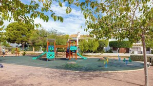 A playground with climbing structures and slides.
