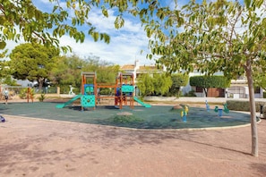 A playground with climbing structures and slides.