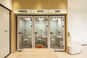 A conference room with three glass-walled booths labeled 'MOBILE,' 'MUTE,' and 'BOX.' Each booth has a white chair and a small table. - Shanghai Zhuxiaoman Urban Hostel (Shanghai)