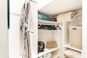 A closet with shelves, a hanging rack, and a storage bin. - Centrally Located, Free Garage Parking! (Cincinnati)