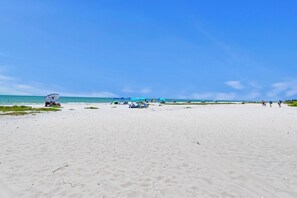 A wide sandy beach with a clear sky. - Wake up to Gulf views at Loggerhead Cay 584, a top-floor 2BR/2BA Sanibel condo overlooking the pool with beautiful side Gulf views + additional water views from the guest bedroom. Enjoy direct beach access, heated pool, tennis/pickleball and more (Sanibel Island)
