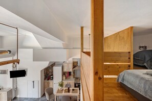 A compact, modern bedroom with a bunk bed, a small desk area, and a kitchenette. - Country House 'Rahati Suite' with Private Terrace and Wi-Fi (Tzermiado)