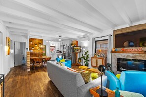 A spacious living area with a dining table, sofas, and a fireplace. - Perfect 4 Families, Walk To Beach, Roof-Top Patio! (Oxnard)