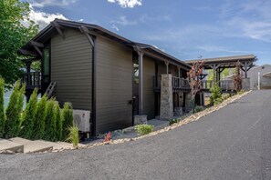 A modern building with a sloped roof, a covered porch, and a stone foundation. - Lakefront Condo B4  Pool in Wapato Point Chelan (Manson)