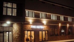 A hotel with a sign that reads 'THE HOTEL' and a brick facade. - Railway Hotel (Wellington)