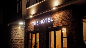 A hotel with a sign reading 'THE HOTEL' above the entrance. - Railway Hotel (Wellington)