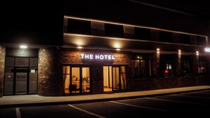 A hotel with a prominent sign reading 'THE HOTEL' and a visible entrance with a glass door. - Railway Hotel (Wellington)