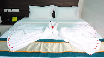 Quarto de hotel com cama, almofadas, telefone e sinalização de cardápio.