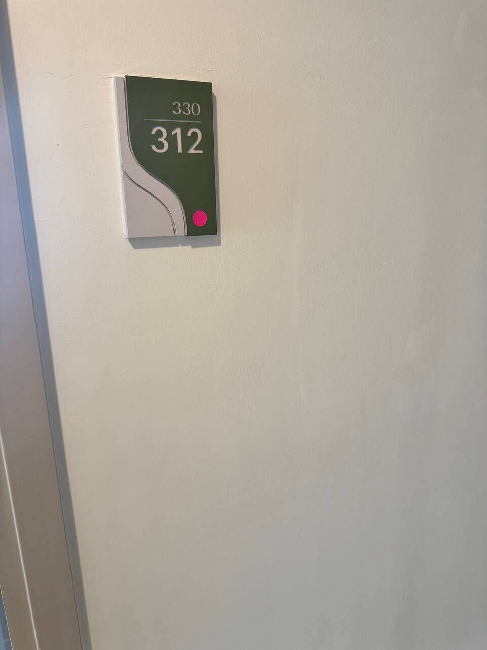 A wall-mounted sign with room numbers 330 and 312.