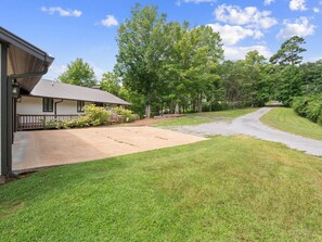 A residential property with a driveway leading to a house, surrounded by lush greenery and trees. - Decked Out in Dismal - Decks and Amenities! (Arley)