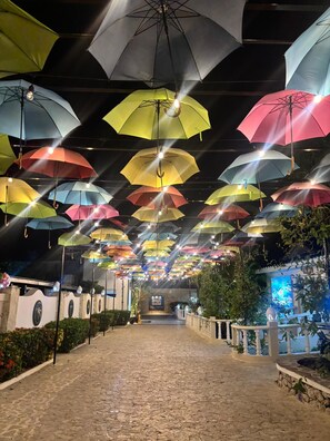 A pathway lined with hanging umbrellas and a stone-tiled floor. - Your Dream Family or Group Getaway: 5 Bedroom Luxury Villa Awaits in Cofresi! (Cofresi)