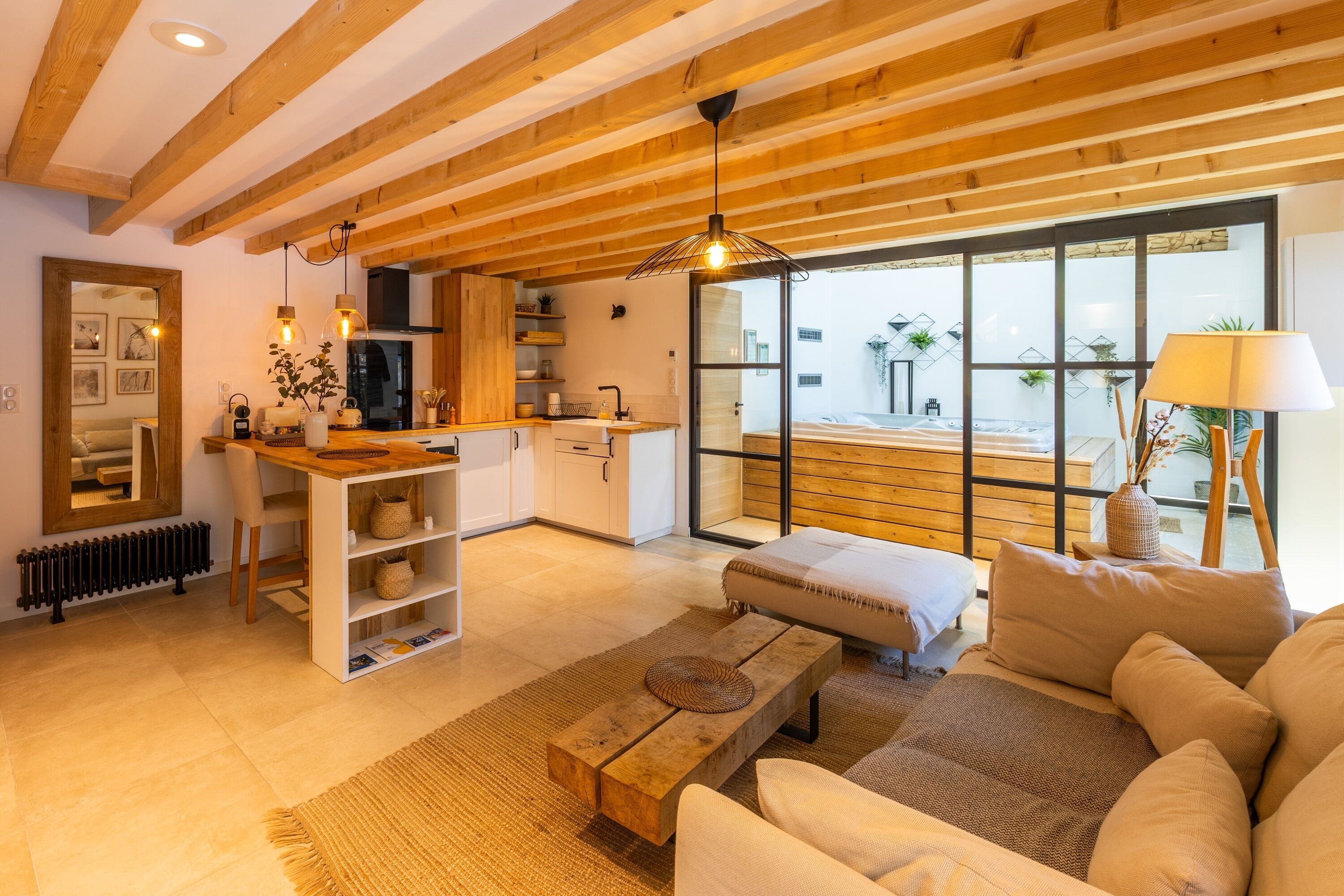 A modern living room with a wooden ceiling, a sofa, a coffee table, and a view of the outside.