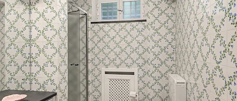 A compact bathroom with a shower, toilet, and sink.