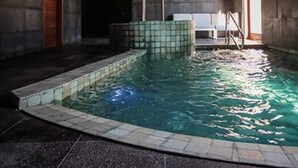 Una piscina interior con paredes y suelo de azulejos.