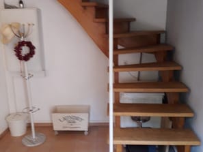 A staircase with wooden steps and a white wall. - Holiday Home Alte Schusterei with Garden, Barbecue Area and Sun Loungers (Badenweiler)