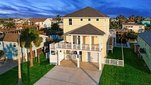 A two-story house with a balcony, a covered porch, and a swimming pool. - Ultimate Waterfront Escape | Pool, Dock, & Views (Jamaica Beach)